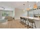 Spacious living room adjacent to the kitchen with stylish bar stools and ample natural light at 5139 50Th W Ave, Bradenton, FL 34210