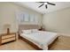 Cozy main bedroom with a platform bed frame, crown molding, and plantation shutters at 5139 50Th W Ave, Bradenton, FL 34210