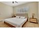 Bright main bedroom featuring a platform bed frame, tile flooring, and plantation shutters at 5139 50Th W Ave, Bradenton, FL 34210