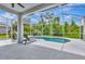 Screened in pool with lounge chairs and lots of green vegetation beyond at 5139 50Th W Ave, Bradenton, FL 34210