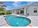 View of a screened in pool with chaise lounges and a custom cooler at 5139 50Th W Ave, Bradenton, FL 34210