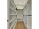 Walk-in closet providing ample storage space with built-in shelving and wooden flooring at 5139 50Th W Ave, Bradenton, FL 34210