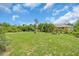Expansive backyard featuring lush greenery, mature trees, and tasteful landscaping at 529 Sunset N Rd, Rotonda West, FL 33947
