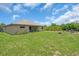 Spacious backyard with lush green grass and minimal landscaping at 529 Sunset N Rd, Rotonda West, FL 33947