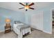Cozy bedroom features tile flooring, a ceiling fan and a closet with white doors at 529 Sunset N Rd, Rotonda West, FL 33947