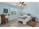 Bright bedroom with light blue walls, ceiling fan, and natural light from a window at 529 Sunset N Rd, Rotonda West, FL 33947