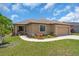 Charming single-story home with a well-manicured lawn and colorful landscaping at 529 Sunset N Rd, Rotonda West, FL 33947