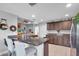 Spacious kitchen featuring dark wood cabinets, granite countertops, and modern appliances at 529 Sunset N Rd, Rotonda West, FL 33947