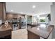 Well-equipped kitchen with stainless steel appliances, granite countertops, and dark wood cabinetry at 529 Sunset N Rd, Rotonda West, FL 33947