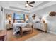 Serene main bedroom with tray ceiling, ceiling fan and woven decor accents at 529 Sunset N Rd, Rotonda West, FL 33947