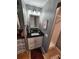 Compact bathroom showcasing a black vanity with storage, a framed mirror, and enclosed shower at 5316 Chateau Ln, Bradenton, FL 34207