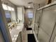 Well-lit bathroom featuring a vanity with a modern countertop and a shower with sliding glass doors at 5316 Chateau Ln, Bradenton, FL 34207