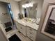 Bathroom featuring a vanity with marble countertops, white cabinetry, and ample lighting at 5316 Chateau Ln, Bradenton, FL 34207