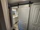 Bathroom with sliding barn door entrance, vanity, and lighting at 5316 Chateau Ln, Bradenton, FL 34207