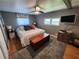 Cozy bedroom with neutral gray walls, a plush rug, and a classic wooden chest at 5316 Chateau Ln, Bradenton, FL 34207