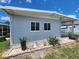 This single-story home boasts light-grey siding, white-trimmed windows and a charming landscaped accent at 5316 Chateau Ln, Bradenton, FL 34207