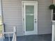 Exterior door with glass and mini blinds, framed by white trim and light gray siding at 5316 Chateau Ln, Bradenton, FL 34207