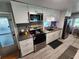 Modern kitchen with stainless steel appliances, white cabinets, and stylish backsplash at 5316 Chateau Ln, Bradenton, FL 34207