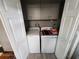 Enclosed laundry room featuring washer, dryer, and storage space at 5316 Chateau Ln, Bradenton, FL 34207