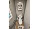 Compact toilet area including wall grab bar, window, and storage basket with decorative accents at 5316 Chateau Ln, Bradenton, FL 34207