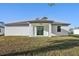 View of the backyard of the house with windows and glass door at 5386 Easter Ter, North Port, FL 34286