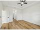 Minimalist bedroom with tray ceilings, ceiling fan, and wood-look floors with natural light at 5386 Easter Ter, North Port, FL 34286