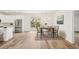 Bright dining area with modern chandelier, dining table, and sliding glass doors leading to the backyard at 5386 Easter Ter, North Port, FL 34286