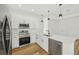 Modern kitchen features stainless steel appliances, sleek white cabinetry, and a stylish black faucet at 5386 Easter Ter, North Port, FL 34286