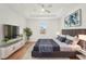 Tastefully furnished primary bedroom featuring a large bed, sleek furniture, and bright window at 5386 Easter Ter, North Port, FL 34286
