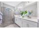 The bathroom features double sinks, granite countertops, a glass enclosed shower and neutral tones at 5981 Amberly Dr, Bradenton, FL 34208