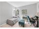 This bedroom offers a twin bed, a desk, a small seating area, and natural light at 5981 Amberly Dr, Bradenton, FL 34208