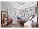 This bright bedroom features a tray ceiling, two windows, a comfortable bed, and a vanity at 5981 Amberly Dr, Bradenton, FL 34208