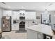 Eat-in kitchen featuring white cabinets and stainless steel appliances and tiled flooring at 5981 Amberly Dr, Bradenton, FL 34208