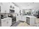Bright kitchen with white cabinets, stainless steel appliances, and island open to the living space at 5981 Amberly Dr, Bradenton, FL 34208