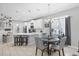 Eat-in kitchen featuring white cabinets, pendant lighting, an island with seating, and a dining table at 5981 Amberly Dr, Bradenton, FL 34208