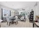 Open concept living room with large sofa, a ceiling fan, dining area, and lots of natural light at 5981 Amberly Dr, Bradenton, FL 34208