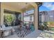 Cozy screened patio with stylish furniture, geometric rug, and view of the manicured backyard at 5981 Amberly Dr, Bradenton, FL 34208