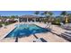 Community pool with lounge chairs and covered seating area on a sunny day at 5981 Amberly Dr, Bradenton, FL 34208