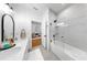 Bright bathroom features double sinks, a soaking tub with glass doors, and a view into another room at 6120 115Th E Ave, Parrish, FL 34219