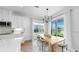 Dining area with modern lighting, a wooden table, and large windows overlooking the yard at 6120 115Th E Ave, Parrish, FL 34219