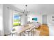 Bright dining area with modern chandelier, table and chairs with a view of the lawn and lake at 6120 115Th E Ave, Parrish, FL 34219