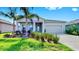 Well-maintained single-Gathering home with a two-car garage, front yard greenery, and colorful shutters at 6120 115Th E Ave, Parrish, FL 34219