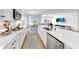 Bright, modern kitchen flows into the living space, showcasing an island and stainless steel appliances at 6120 115Th E Ave, Parrish, FL 34219