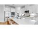 Modern kitchen with white cabinets, a large island with seating, and stainless steel appliances at 6120 115Th E Ave, Parrish, FL 34219