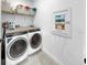 Practical laundry room with modern washer and dryer, storage shelving, and convenient wall panel at 6120 115Th E Ave, Parrish, FL 34219