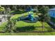 This beautiful playground features bright colors, green grass, mature trees, and a safety fence at 6120 115Th E Ave, Parrish, FL 34219