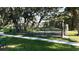 This beautiful tennis court is fenced in and surrounded by lovely mature trees and lush green grass at 6120 115Th E Ave, Parrish, FL 34219