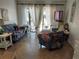 Bright living room with tile flooring, sheer curtains, and a comfortable, cozy atmosphere for relaxation and entertainment at 6132 29Th W Ave, Bradenton, FL 34209