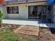 Back patio area with sliding glass doors, space for outdoor seating, and potential for landscaping to enhance the yard at 6132 29Th W Ave, Bradenton, FL 34209
