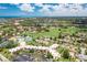 Expansive aerial view of the community showcasing lush landscaping, amenities, and beautiful blue skies at 618 Bird Bay S Dr # 113, Venice, FL 34285